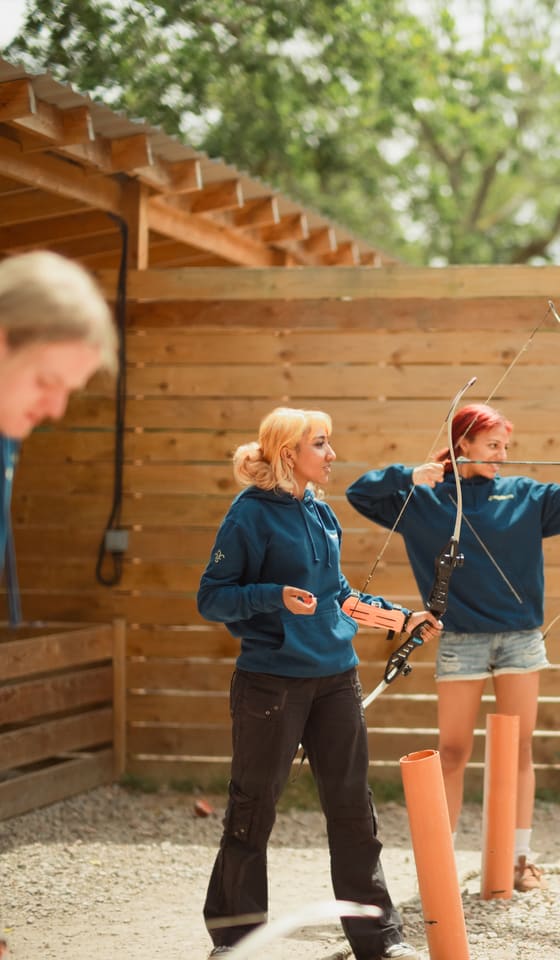 Explorers shooting archery at a district activity day.